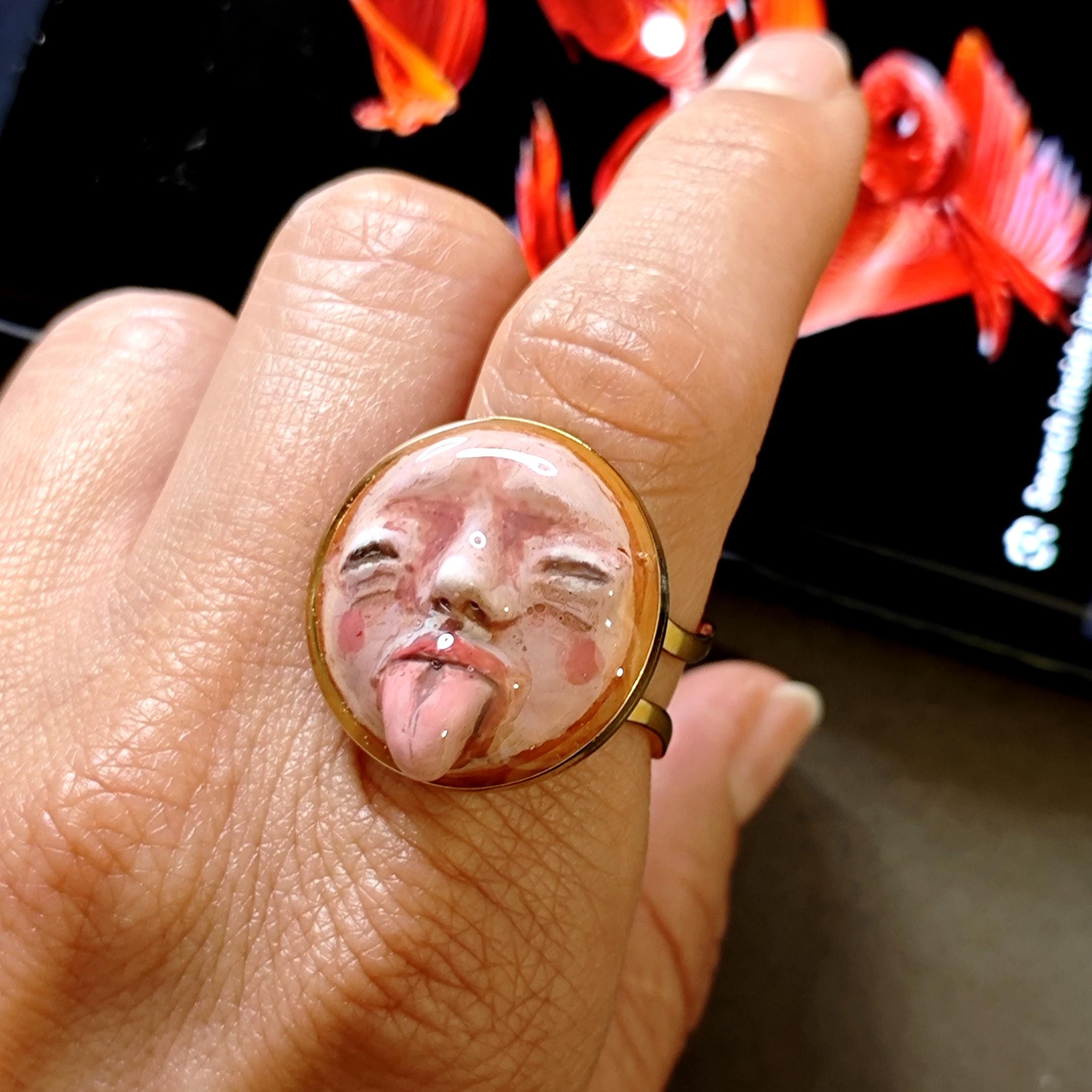 Tongue Out Face Ring ā Handmade Clay & Resin Surreal Statement Jewelry, Closed Eyes Sculptural Wearable Art, Adjustable Stainless Steel Band
